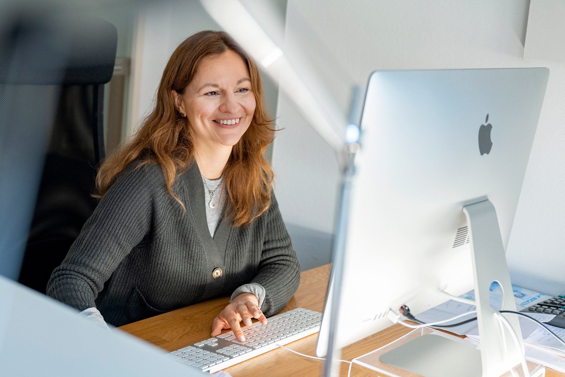 Mitarbeiterin von werbeagentur marketing vor einem Rechner